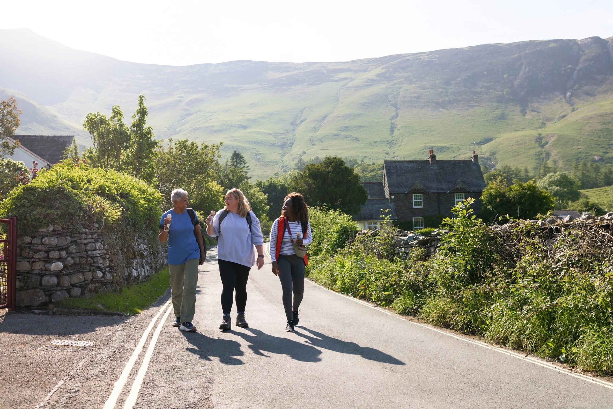 Women enjoying conversation during a countryside walk